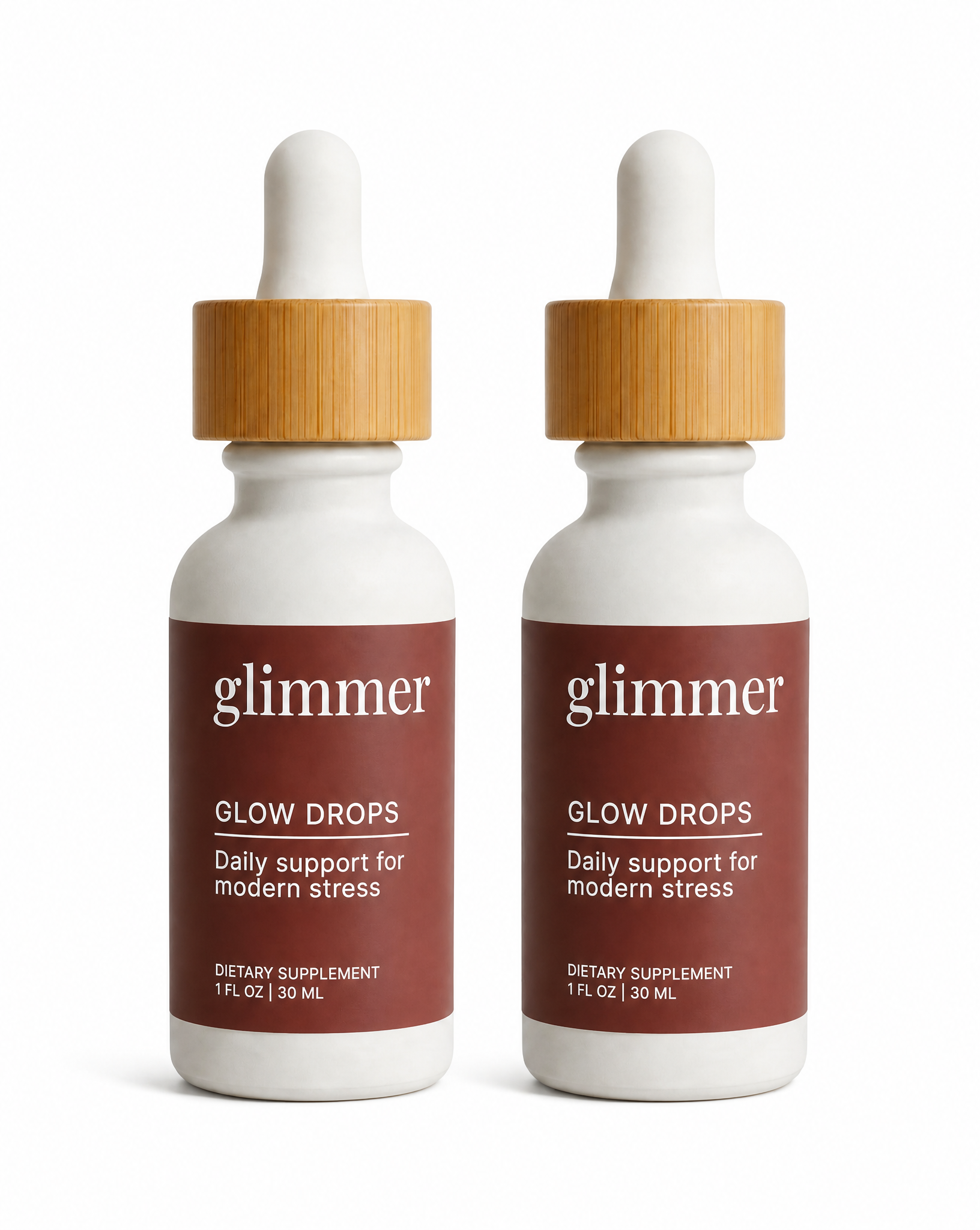 Two bottles of Glimmer's Glow Drops with wooden caps on a white background
